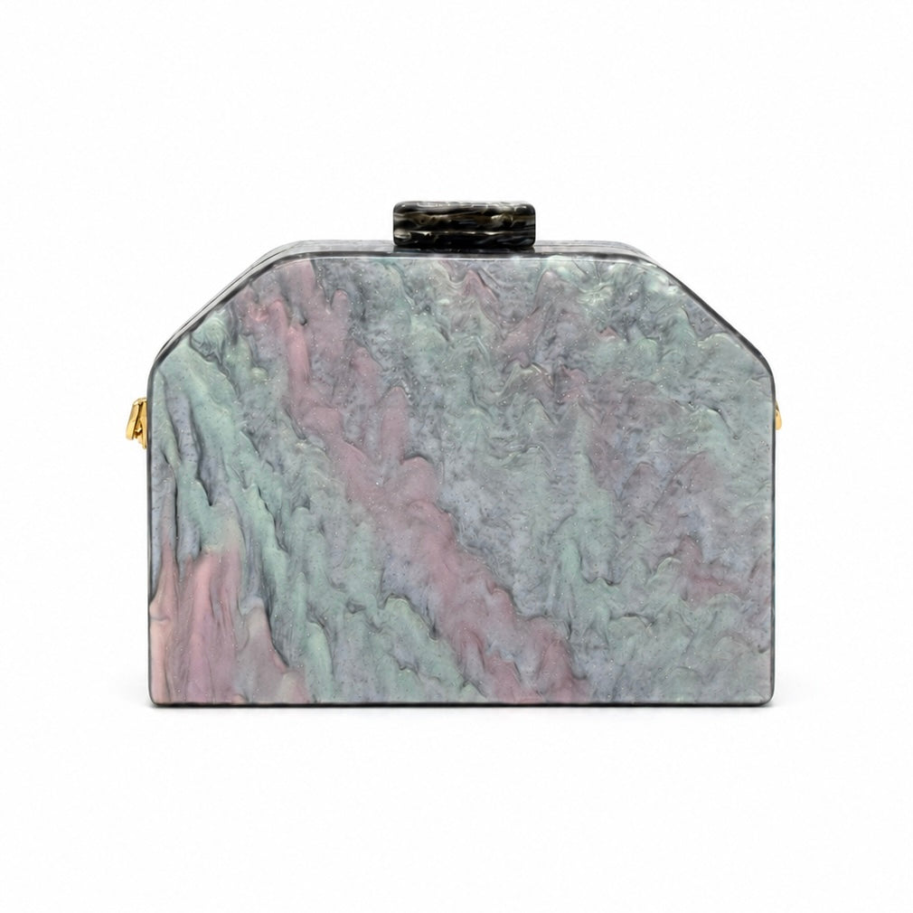 L’APOGÉE Nocturne geometric acrylic clutch featuring smoky black, charcoal, ivory, and grey marbled tones with a sculptural angular silhouette designed for formal events, dinners, and sophisticated evening styling.
