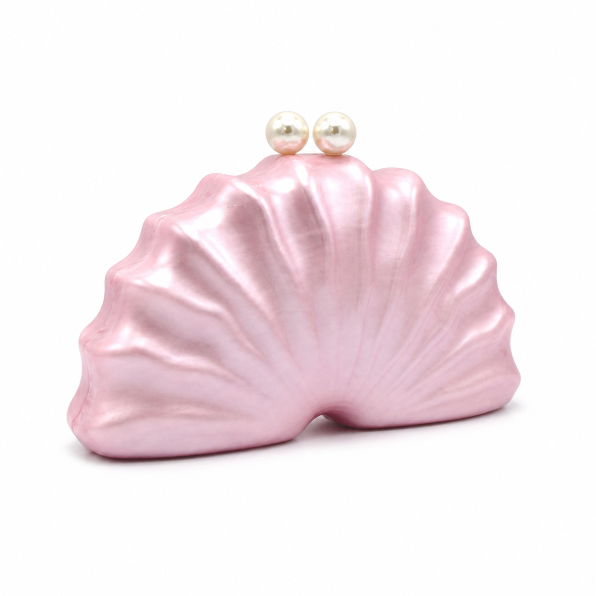 L’APOGÉE Naïelle shell-inspired acrylic clutch featuring soft blush pink finishes, sculptural oceanic curves, and pearl clasp detailing designed for feminine evening styling and elegant statement fashion looks.