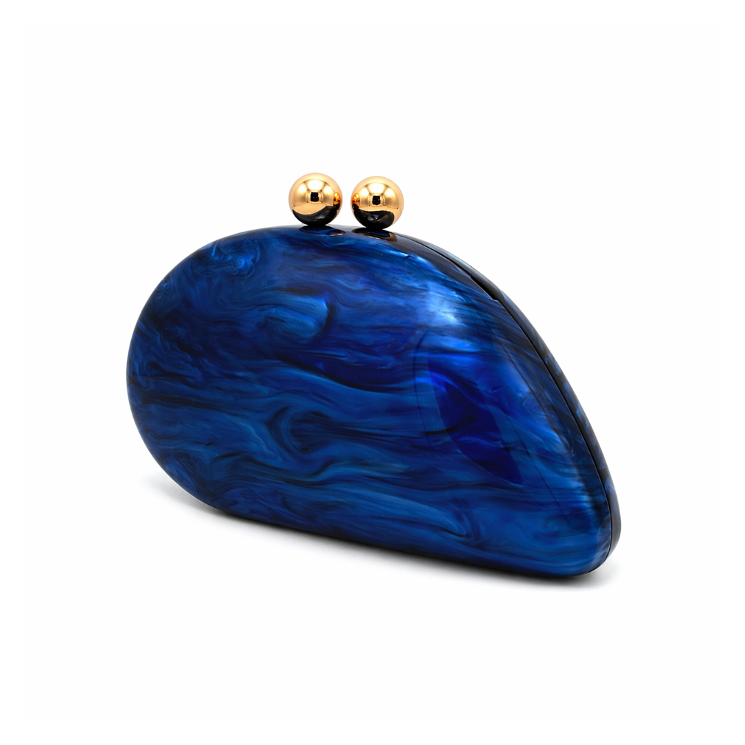 L’APOGÉE Alexandria in Navy shell-shaped acrylic evening bag featuring deep navy marbled tones and a sculptural curved silhouette designed for formal events, dinners, and elegant night styling.