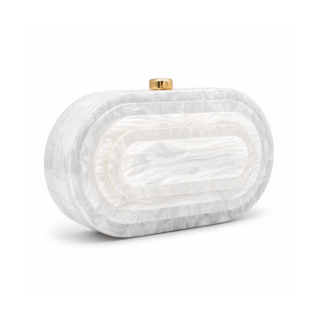 L’APOGÉE Olympia in White layered oval acrylic clutch featuring glossy white marbled tones and a sculptural concentric silhouette designed for weddings, formal events, and elegant evening styling.