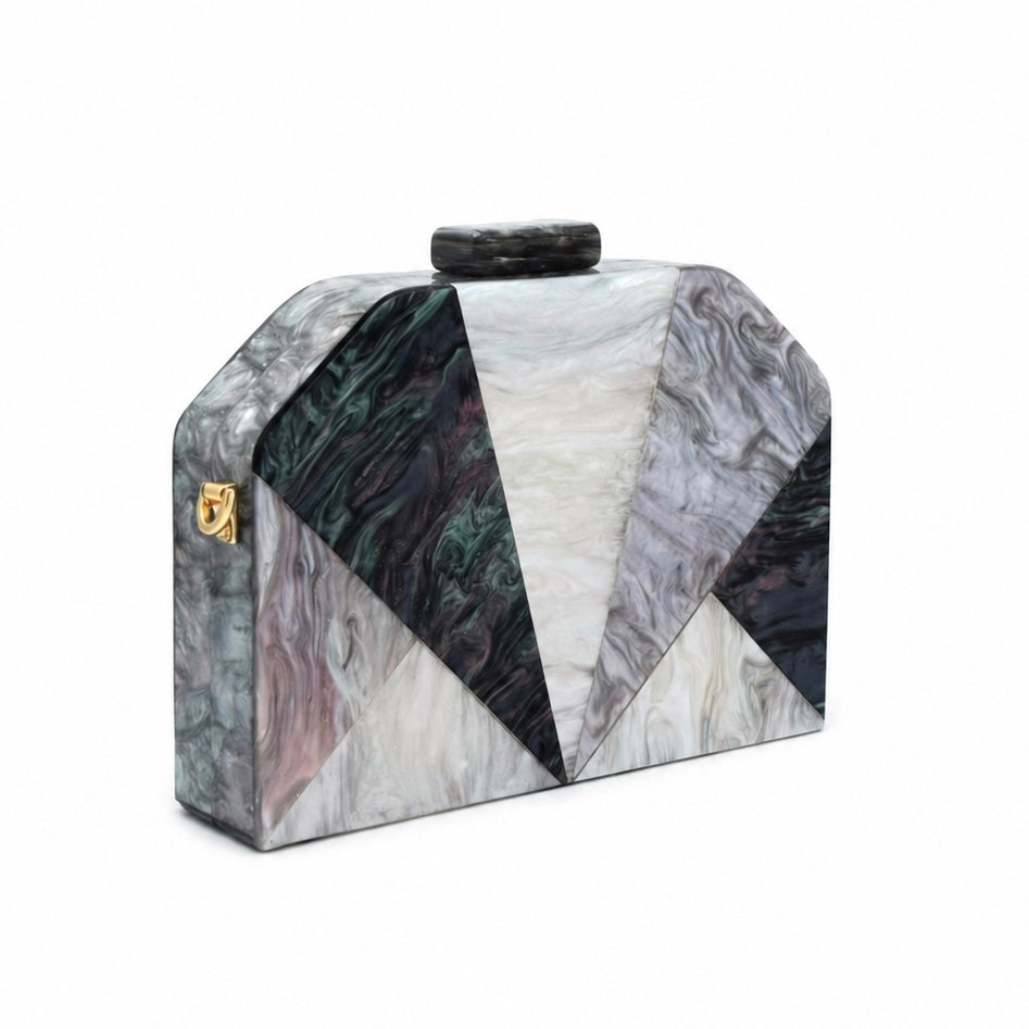 L’APOGÉE Nocturne geometric acrylic clutch featuring smoky black, charcoal, ivory, and grey marbled tones with a sculptural angular silhouette designed for formal events, dinners, and sophisticated evening styling.