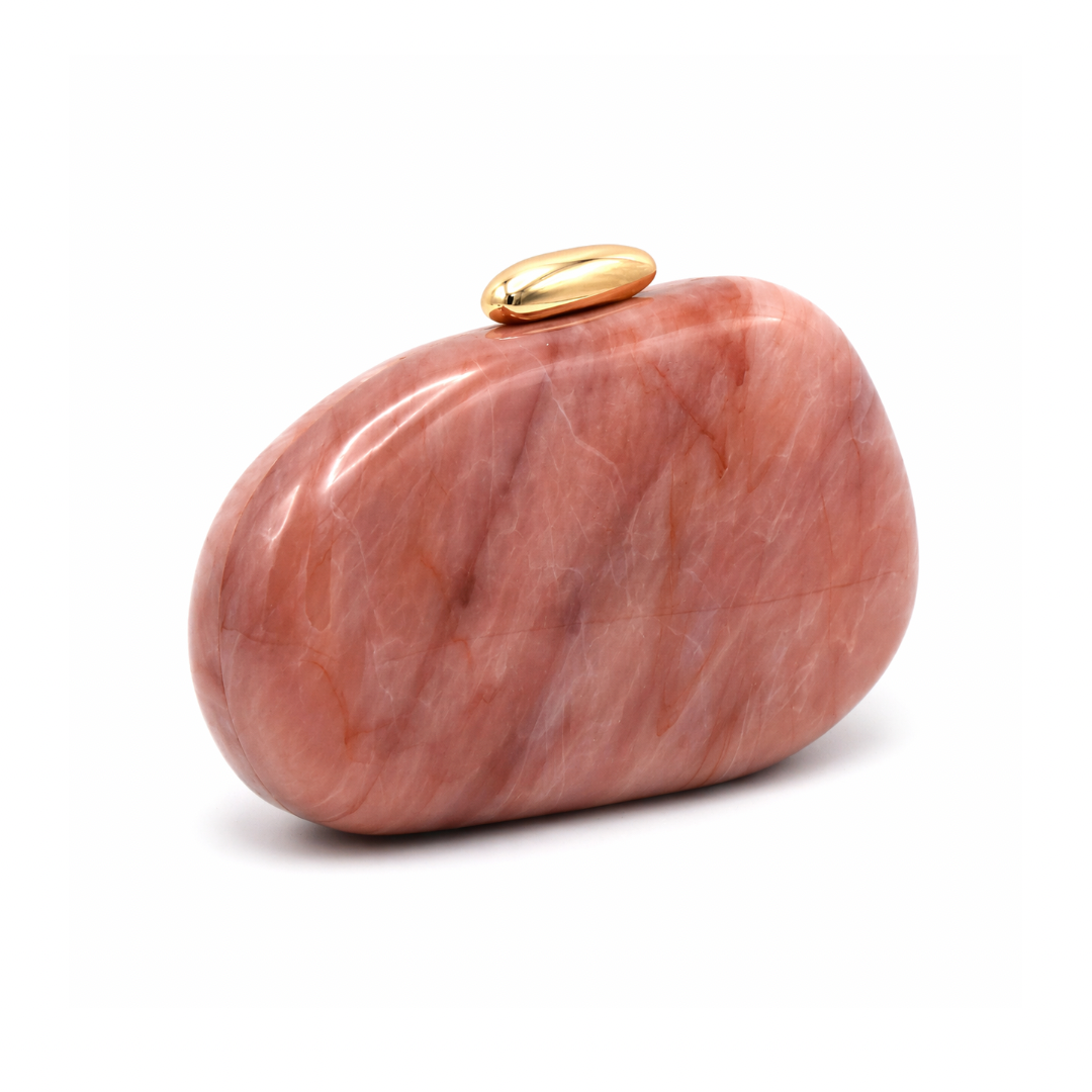 L’APOGÉE Puissance in Blush Quartz sculptural oval acrylic evening bag featuring soft blush quartz marbled tones and a glossy gold clasp designed for weddings, dinners, and elegant statement occasion styling.