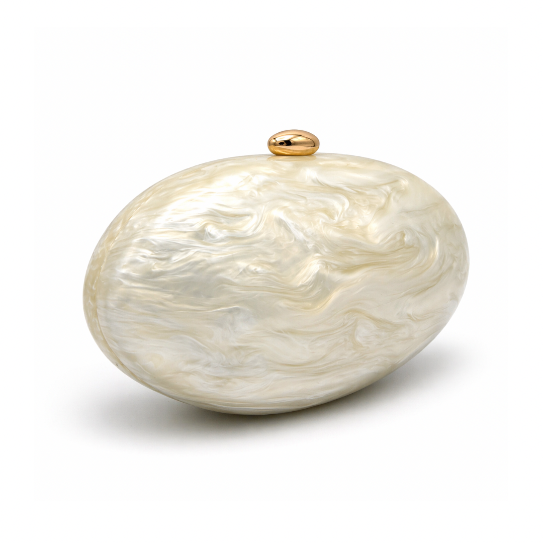 L’APOGÉE Calypso in Ivory sculptural oval acrylic evening bag featuring pearly ivory marbled tones and a rounded statement silhouette designed for weddings, luxury dinners, and elegant occasion styling.