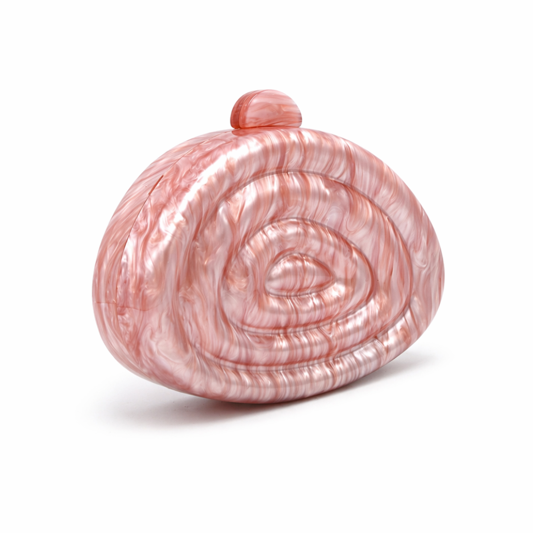 L’APOGÉE Zemira in Rosewood sculptural acrylic clutch featuring warm rosewood marbled tones, an organic asymmetrical silhouette with concentric carved detailing, and a glossy statement finish designed for elegant dinners and sophisticated evening looks.