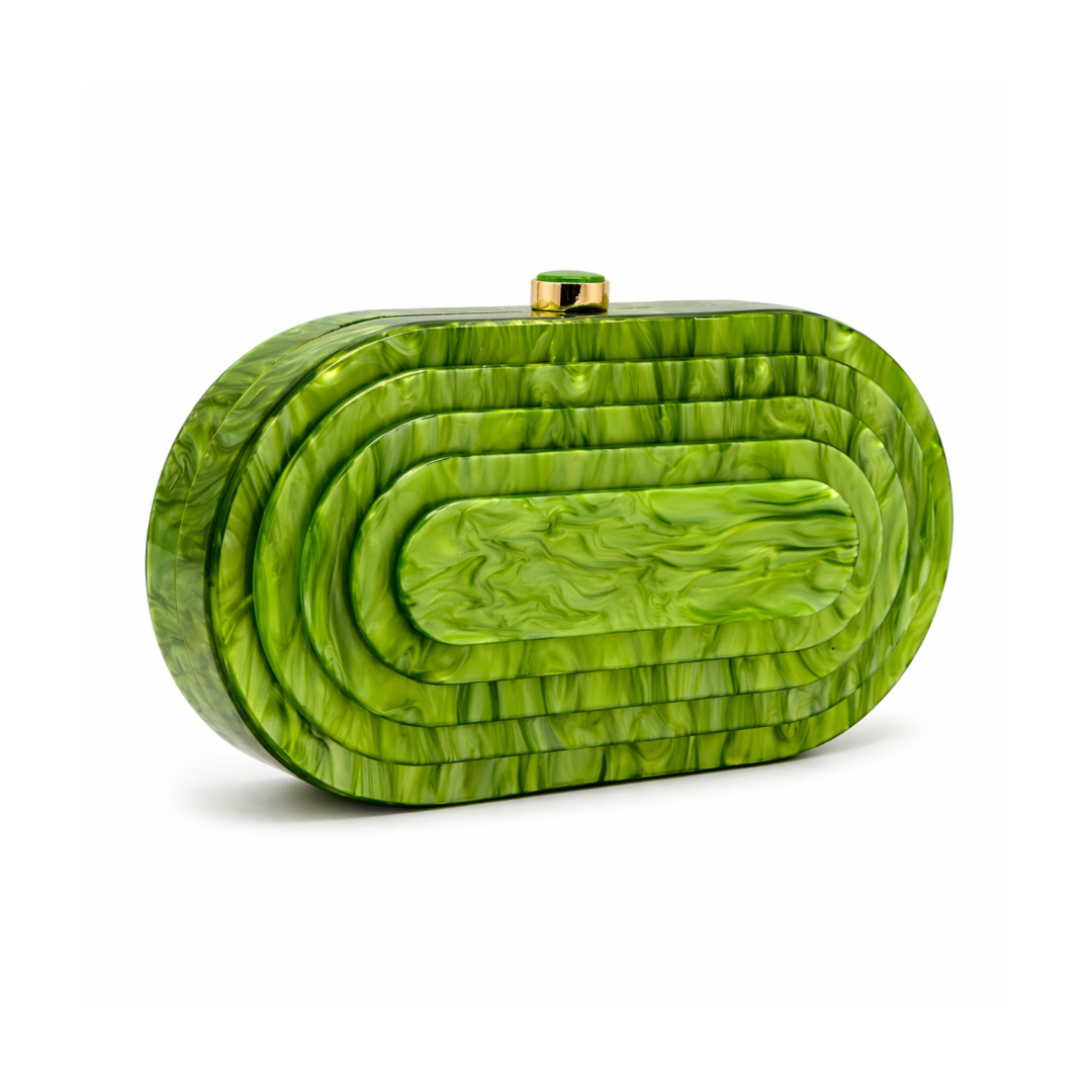 L’APOGÉE Olympia in Pistache layered oval acrylic clutch featuring glossy pistachio green marbled tones and a sculptural concentric silhouette designed for vacations, brunches, and statement occasion styling.