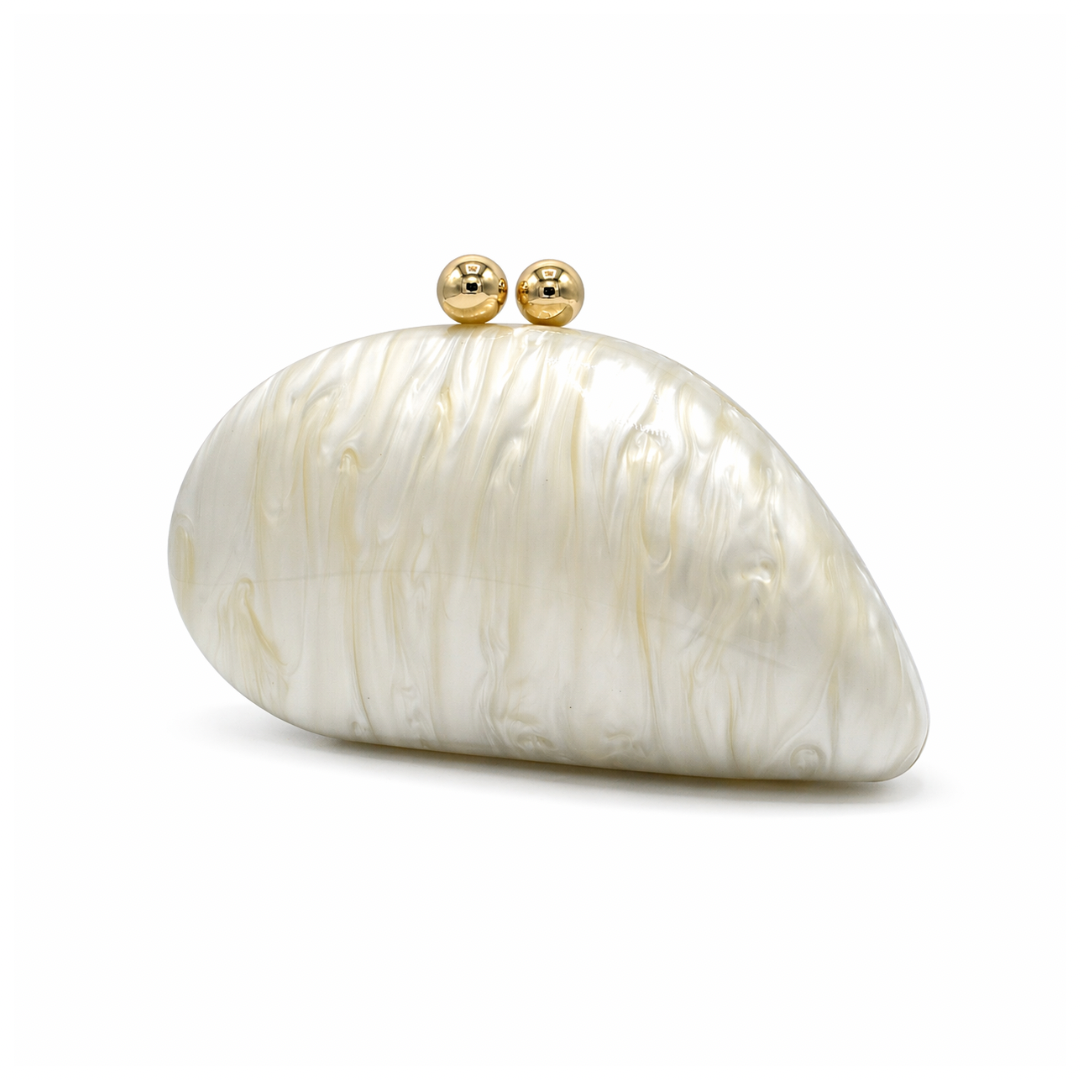 L’APOGÉE Alexandria in Ivory shell-shaped acrylic evening bag featuring pearly ivory marbled tones and a sculptural curved silhouette designed for weddings, formal events, and timeless elegant styling.