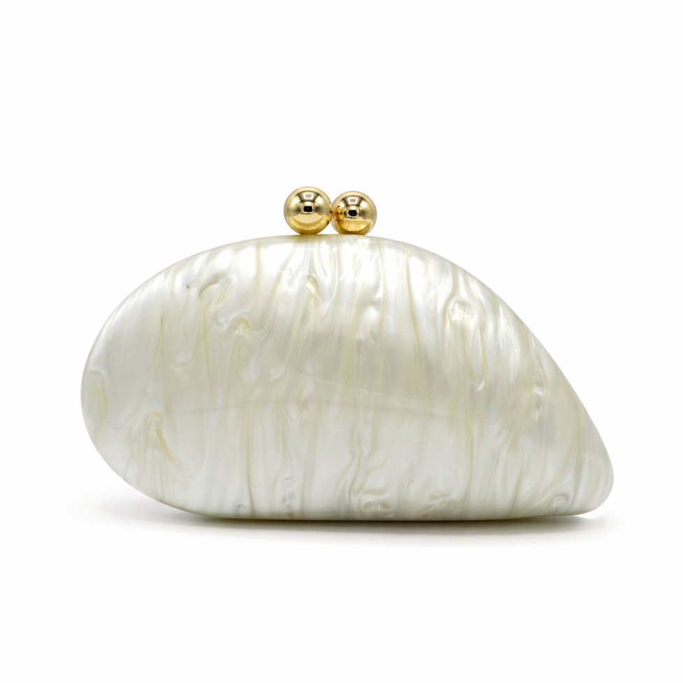 L’APOGÉE Alexandria in Ivory shell-shaped acrylic evening bag featuring pearly ivory marbled tones and a sculptural curved silhouette designed for weddings, formal events, and timeless elegant styling.