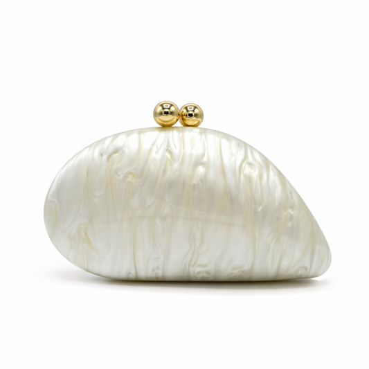 L’APOGÉE Alexandria in Ivory shell-shaped acrylic evening bag featuring pearly ivory marbled tones and a sculptural curved silhouette designed for weddings, formal events, and timeless elegant styling.
