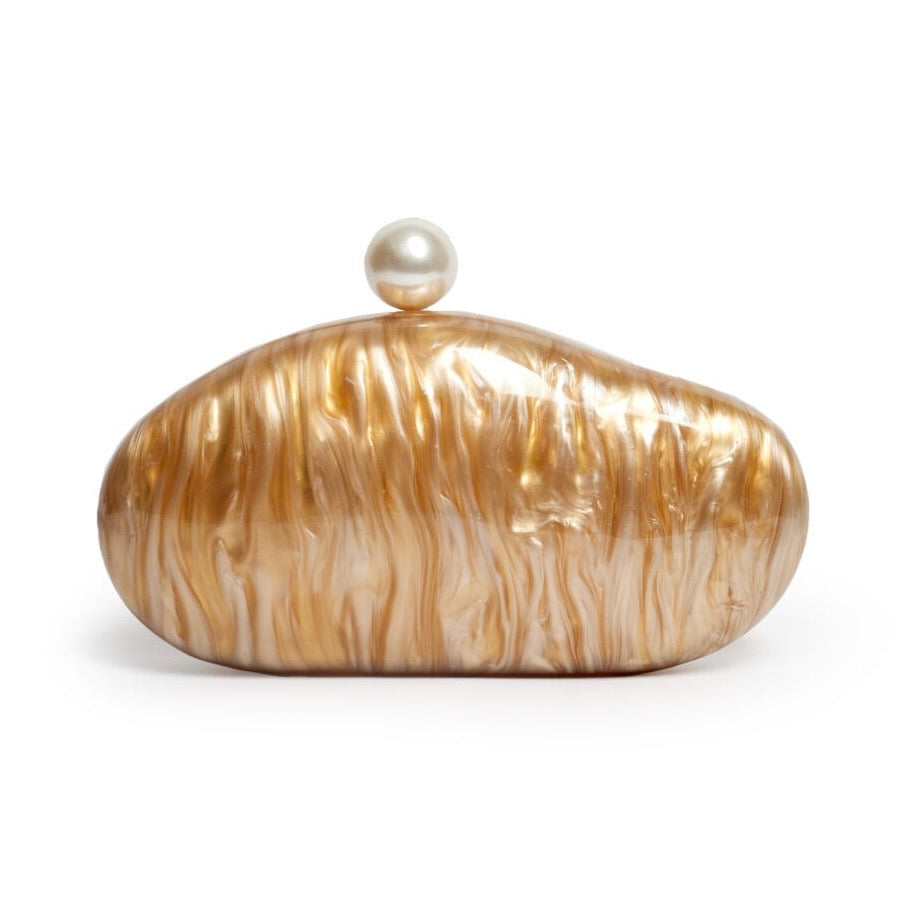 L’APOGÉE Alméa in Caramel sculptural acrylic clutch featuring glossy caramel marbled textures, a smooth organic silhouette, and pearl-inspired detailing designed for sophisticated evening styling and statement fashion looks.