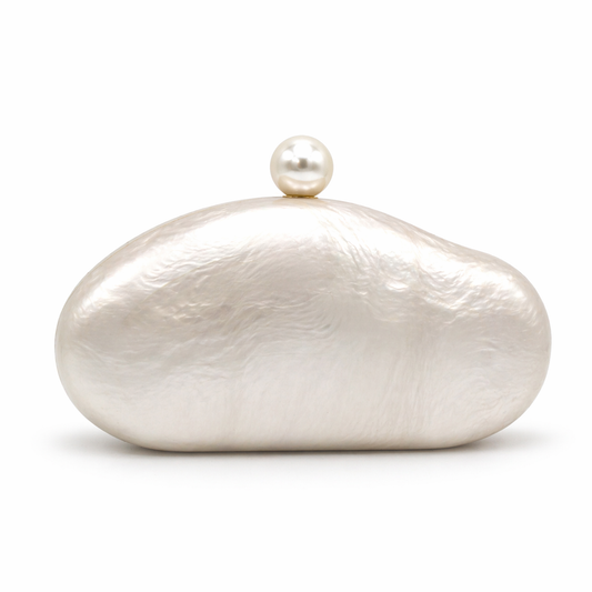 L’APOGÉE Alméa in Pearl sculptural acrylic clutch featuring pearly ivory finishes, a smooth organic silhouette, and pearl-inspired detailing designed for bridal events, elegant dinners, and luxury evening styling.