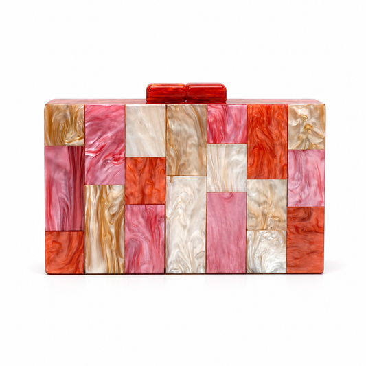 L’APOGÉE Bloom rectangular acrylic clutch featuring geometric marbled panels in pink, coral, ivory, and warm orange tones designed for playful luxury styling, summer events, and colorful evening looks.