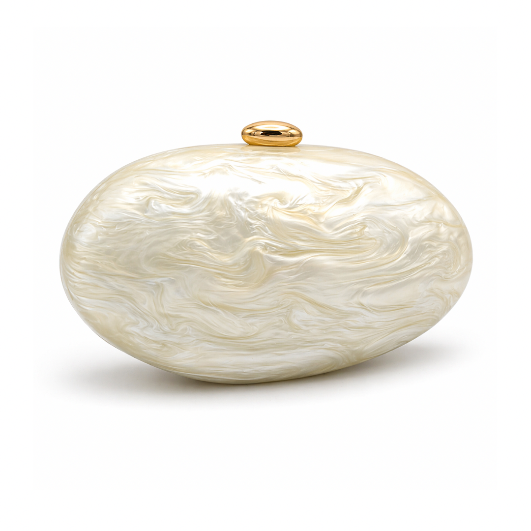 L’APOGÉE Calypso in Ivory sculptural oval acrylic evening bag featuring pearly ivory marbled tones and a rounded statement silhouette designed for weddings, luxury dinners, and elegant occasion styling.