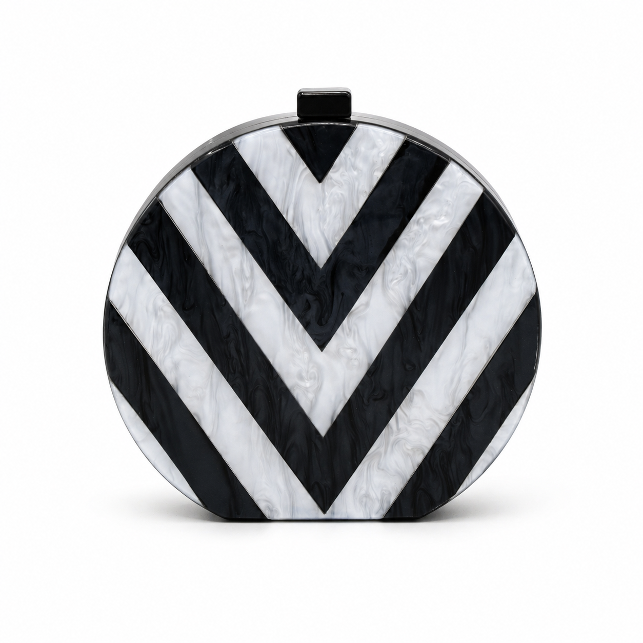 L’APOGÉE Chroma round acrylic clutch featuring bold black and white geometric striped patterns with a sculptural circular silhouette designed for modern evening styling and monochrome fashion statements.