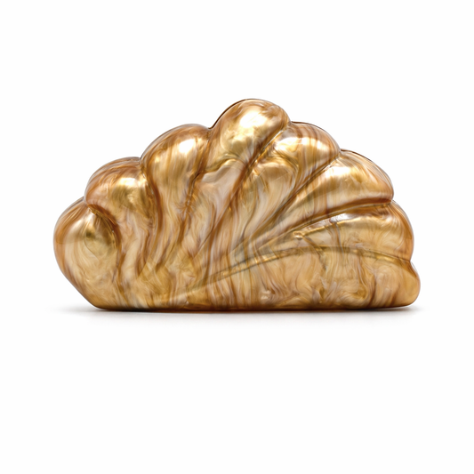 L’APOGÉE Coralline in Caramel shell-inspired acrylic clutch featuring warm caramel marbled finishes, sculptural oceanic curves, and an artistic silhouette designed for sophisticated evening styling and statement fashion moments.