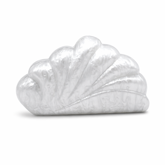 L’APOGÉE Coralline in White shell-inspired acrylic clutch featuring pearly white finishes, sculptural oceanic curves, and an artistic silhouette designed for bridal styling and elegant luxury evening looks.