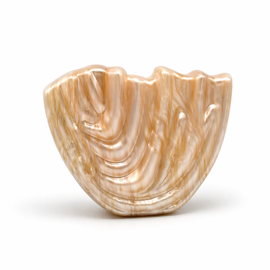 L’APOGÉE Drapée in Beige sculptural acrylic clutch featuring flowing carved textures, warm beige marbled finishes, and an artistic organic silhouette designed for luxury evening styling and modern statement fashion looks.