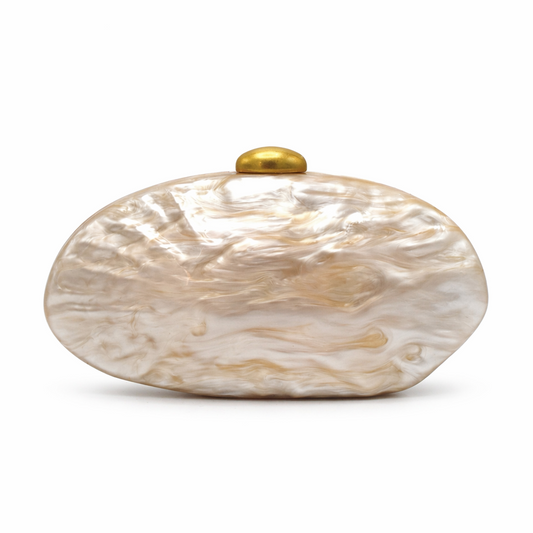 L’APOGÉE Lithéa oval acrylic clutch featuring glossy beige marbled finishes, a smooth sculptural silhouette, and elegant metallic clasp detailing designed for refined evening styling and luxury fashion moments.