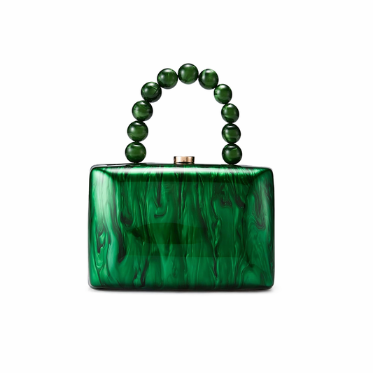 L’APOGÉE Malachéa structured acrylic clutch featuring rich emerald green marbled textures, a glossy rectangular silhouette, and a sculptural green beaded top handle designed for luxury evening styling and bold statement fashion looks.