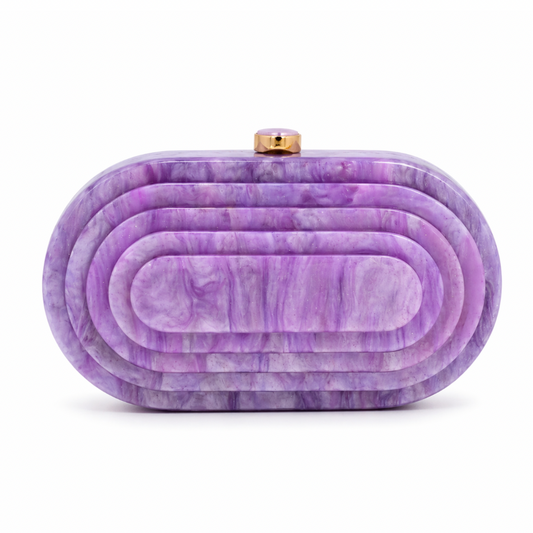 L’APOGÉE Olympia in Lila layered oval acrylic clutch featuring soft lilac marbled tones and a sculptural concentric silhouette designed for parties, weddings, and feminine occasion styling.