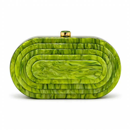 L’APOGÉE Olympia in Pistache layered oval acrylic clutch featuring glossy pistachio green marbled tones and a sculptural concentric silhouette designed for vacations, brunches, and statement occasion styling.