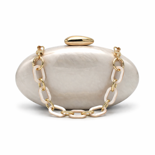 L’APOGÉE Opaline sculptural oval acrylic evening bag featuring glossy pearly marbled tones, a rounded statement silhouette, and chunky gold chain detailing designed for weddings, formal events, and elegant occasion styling.