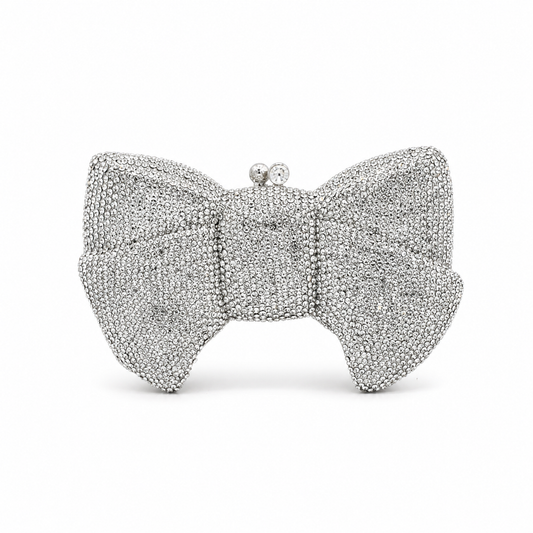 L’APOGÉE Pretty Please Silver bow evening bag featuring rhinestone embellishments designed for weddings, formal events, and glamorous occasion styling.