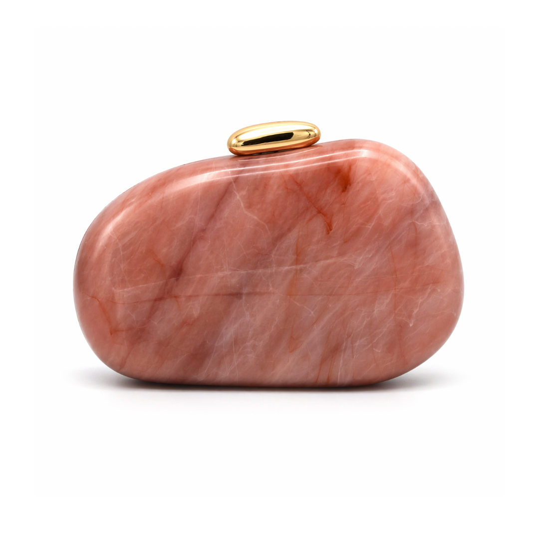 L’APOGÉE Puissance in Blush Quartz sculptural oval acrylic evening bag featuring soft blush quartz marbled tones and a glossy gold clasp designed for weddings, dinners, and elegant statement occasion styling.