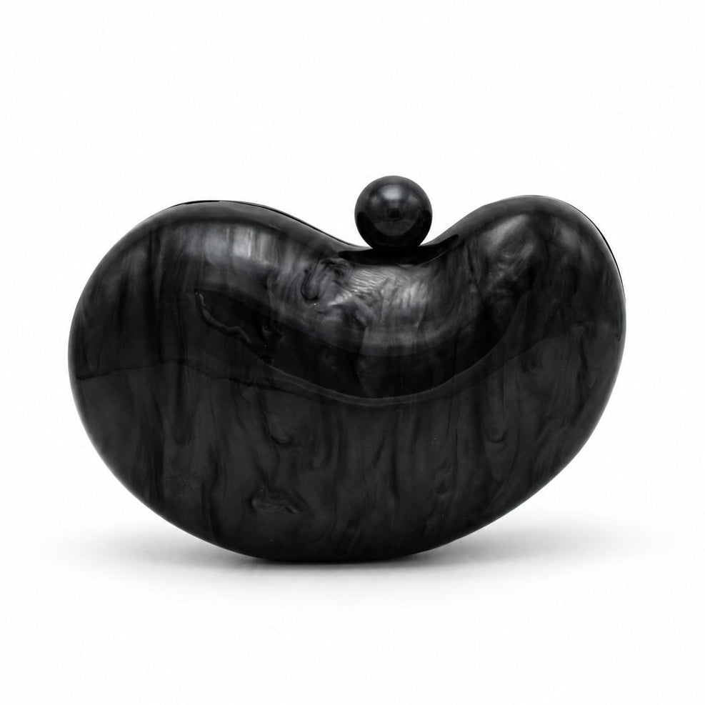 L’APOGÉE Solace in Black sculptural rounded acrylic evening bag featuring glossy black marbled tones and a sleek statement silhouette designed for formal events, evening dinners, and timeless elegant styling.