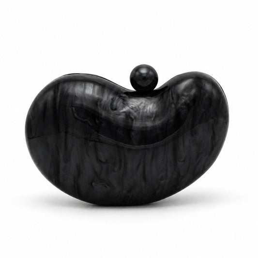L’APOGÉE Solace in Black sculptural rounded acrylic evening bag featuring glossy black marbled tones and a sleek statement silhouette designed for formal events, evening dinners, and timeless elegant styling.