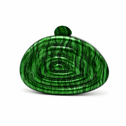 L’APOGÉE Zemira in Green sculptural acrylic clutch featuring rich emerald green marbled textures, an organic asymmetrical silhouette with concentric carved detailing, and a glossy statement finish designed for bold evening styling and luxury fashion events.