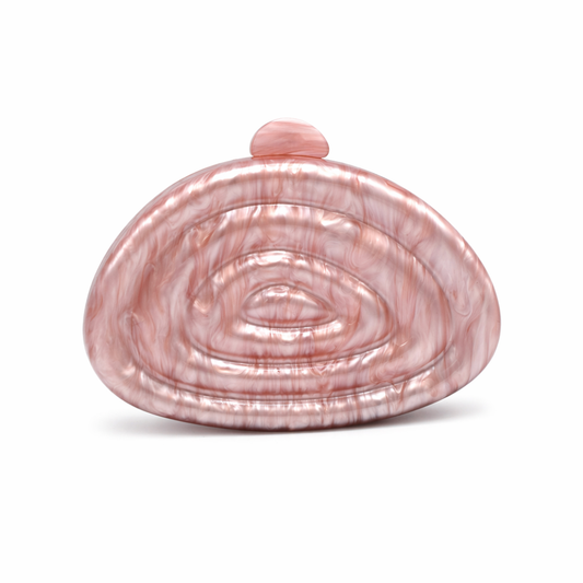 L’APOGÉE Zemira in Rosewood sculptural acrylic clutch featuring warm rosewood marbled tones, an organic asymmetrical silhouette with concentric carved detailing, and a glossy statement finish designed for elegant dinners and sophisticated evening looks.